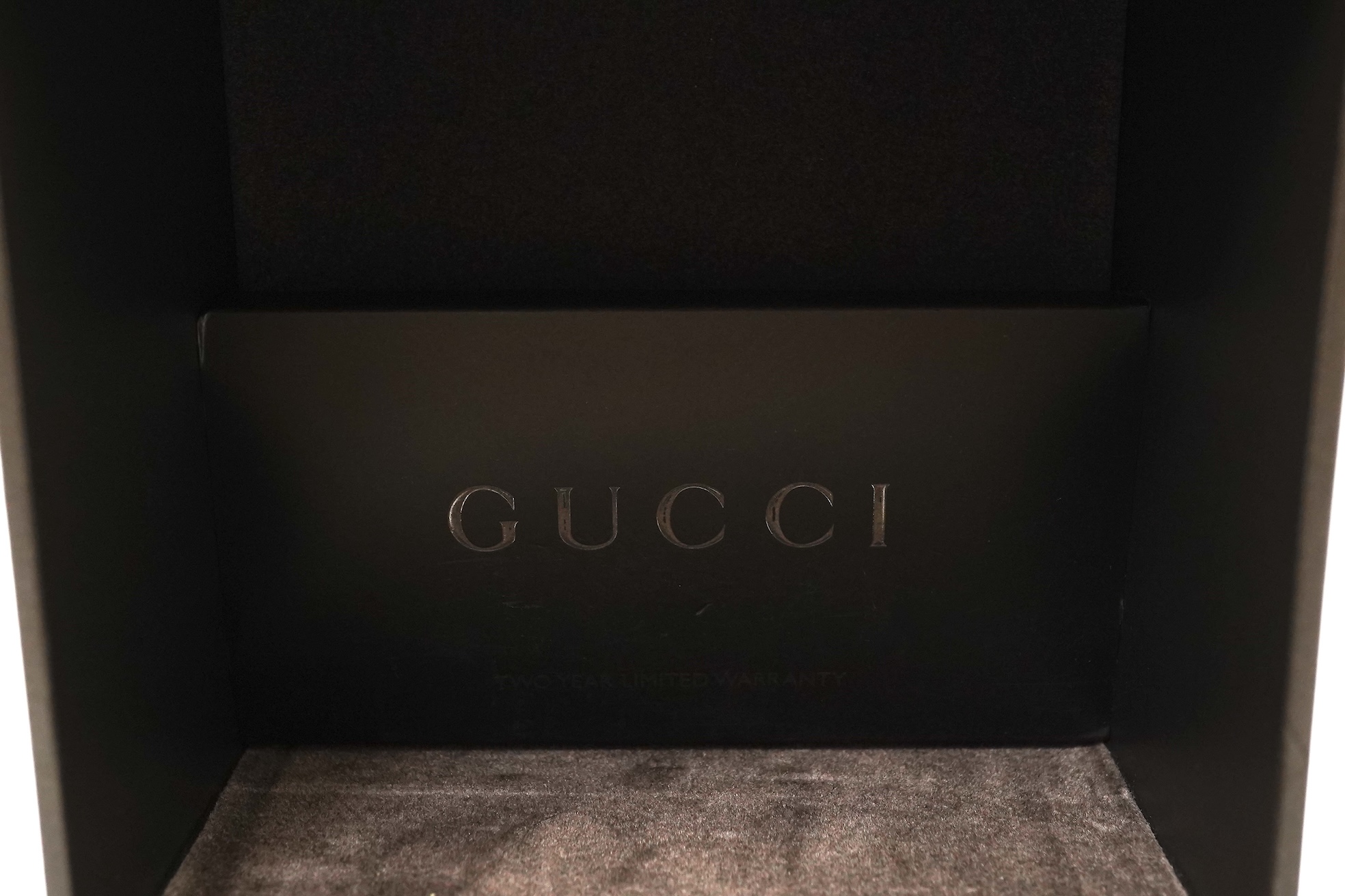 A lady's Gucci watch with wide leather strap, with box and papers.